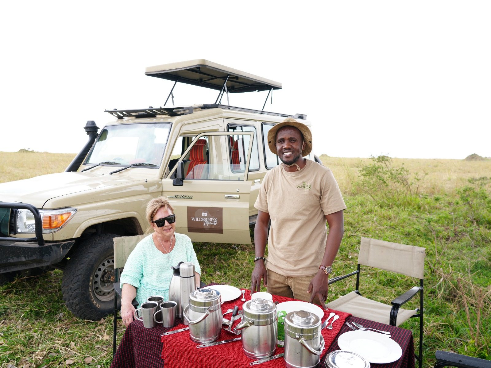 Wilderness Moments Tours guests and guide with the safari vehicle