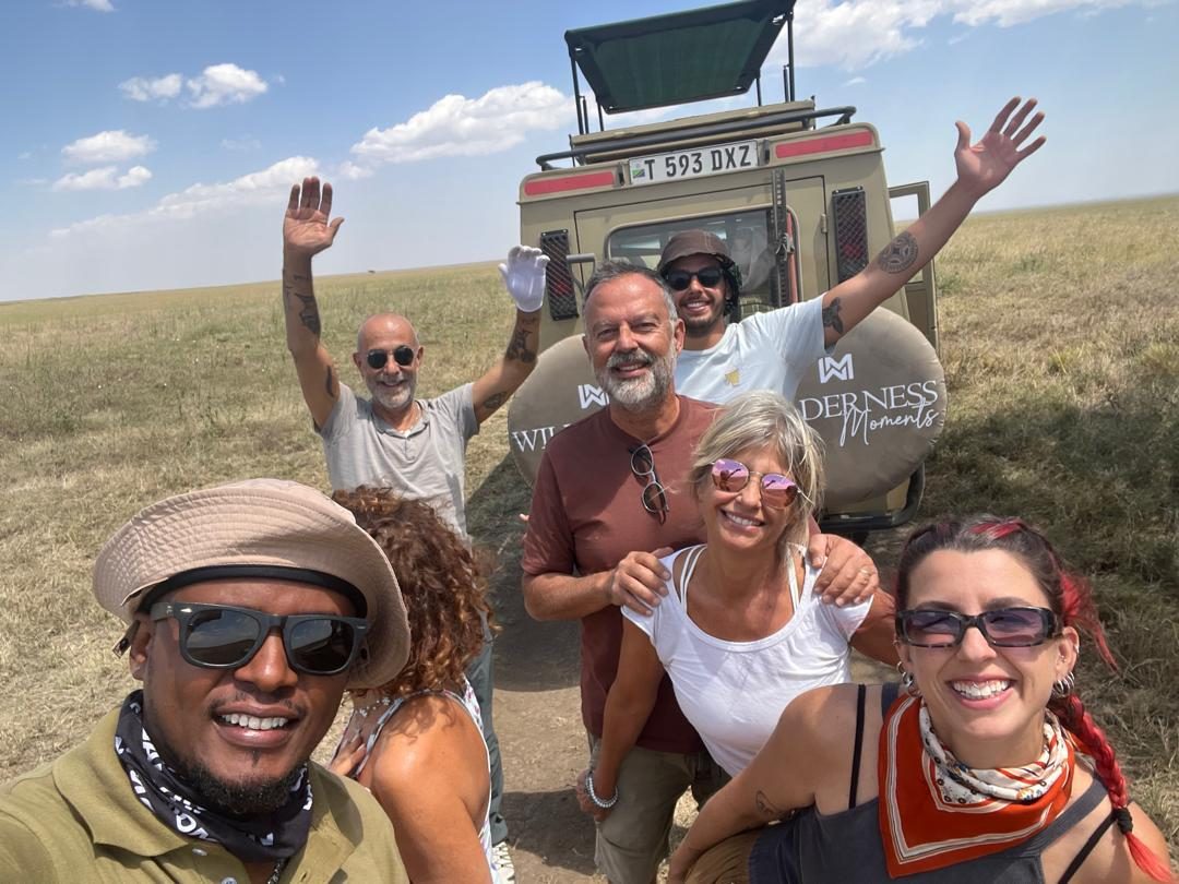 Group with Wilderness Moments safari vehicle in the Serengeti