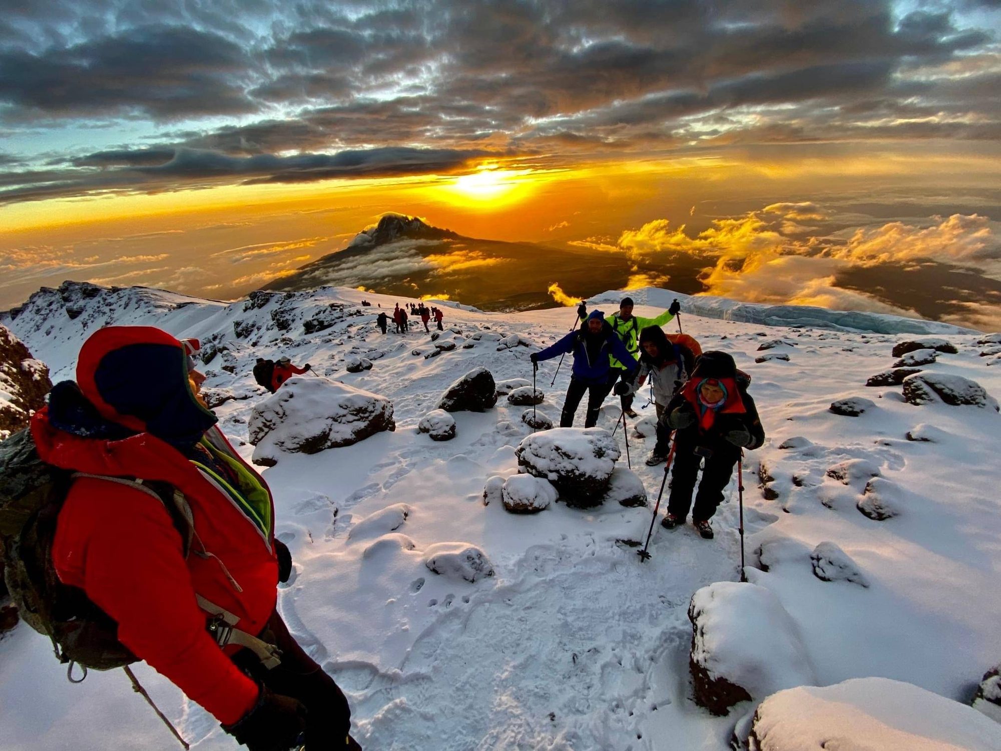 Hikers watching sunset near Mawenzi peak on Mount Kilimanjaro