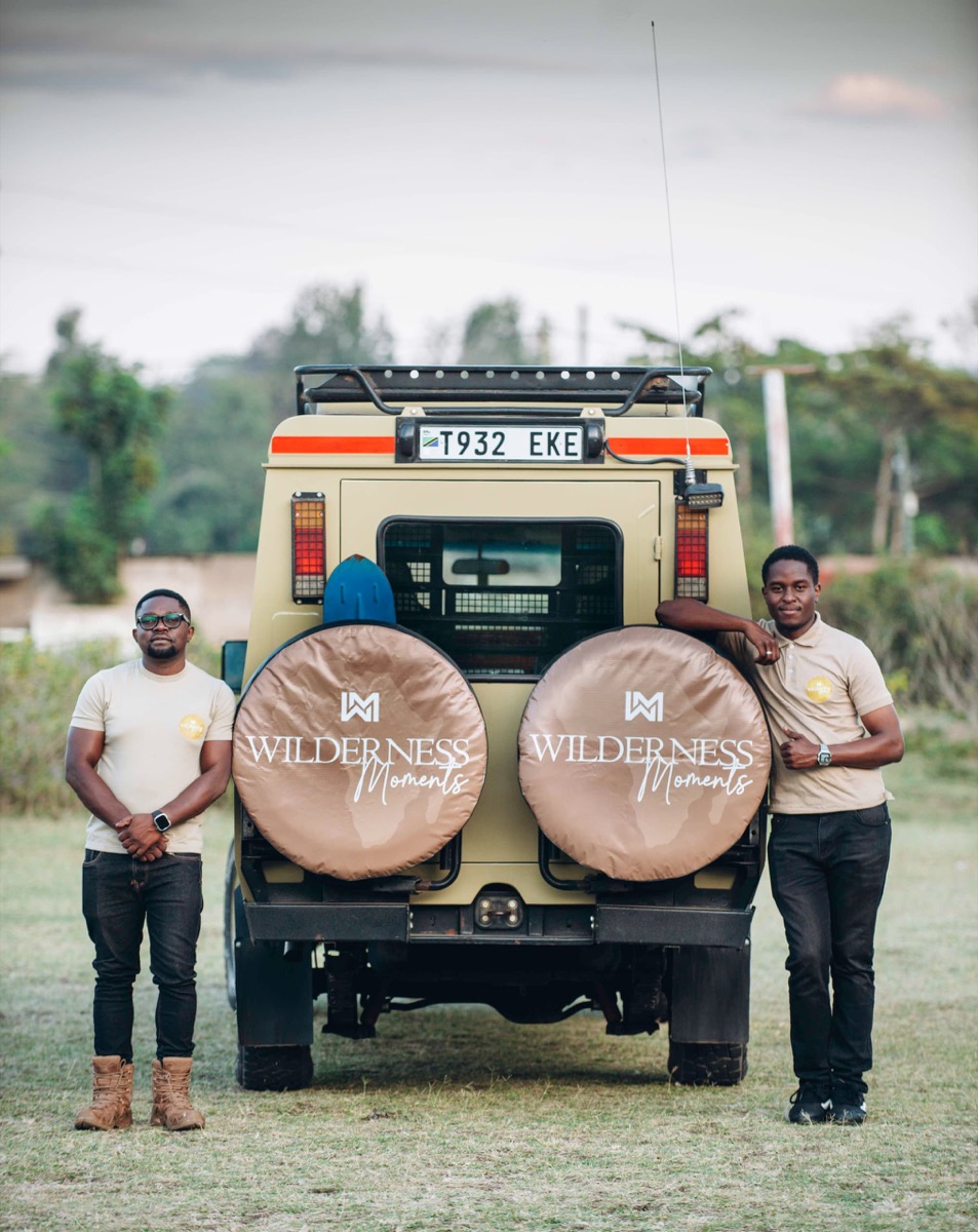 Two Wilderness Moments guides beside the safari vehicle