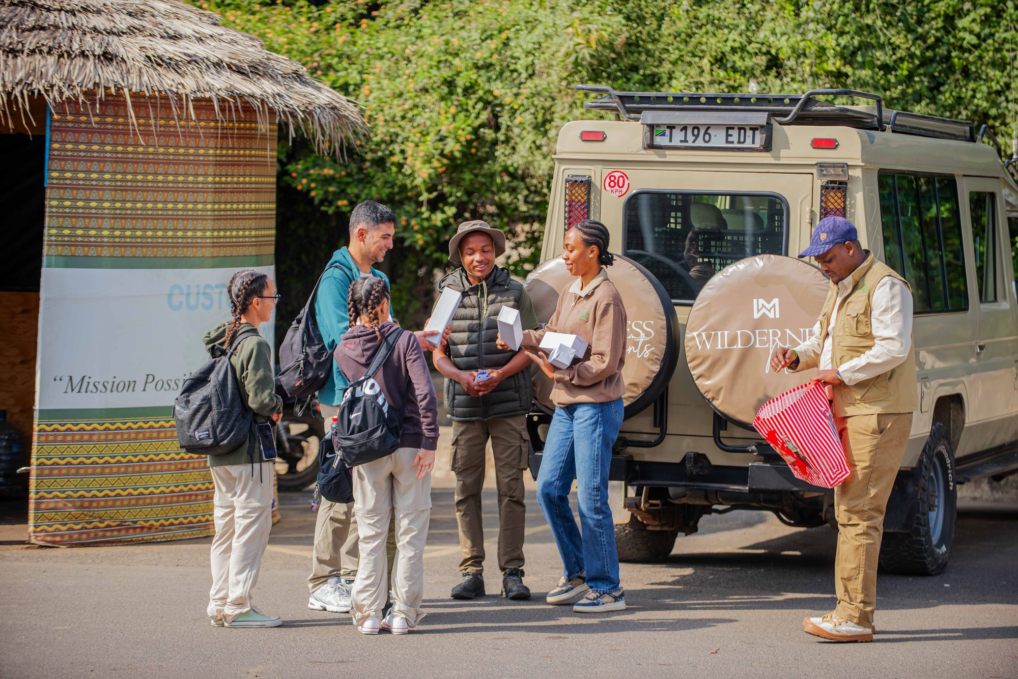 Guests gathering by the Land Cruiser before departure