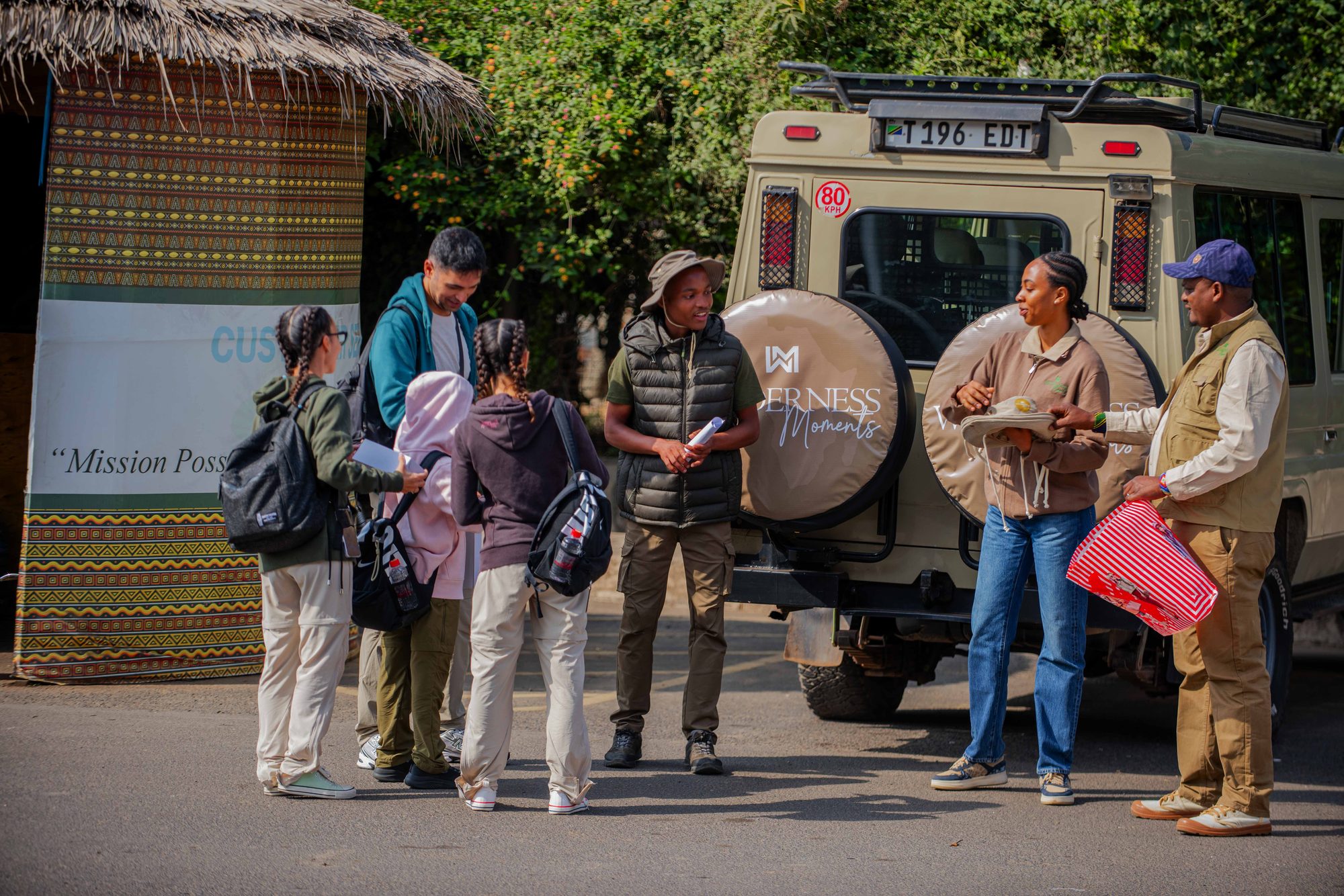 The whole group by our branded safari vehicle