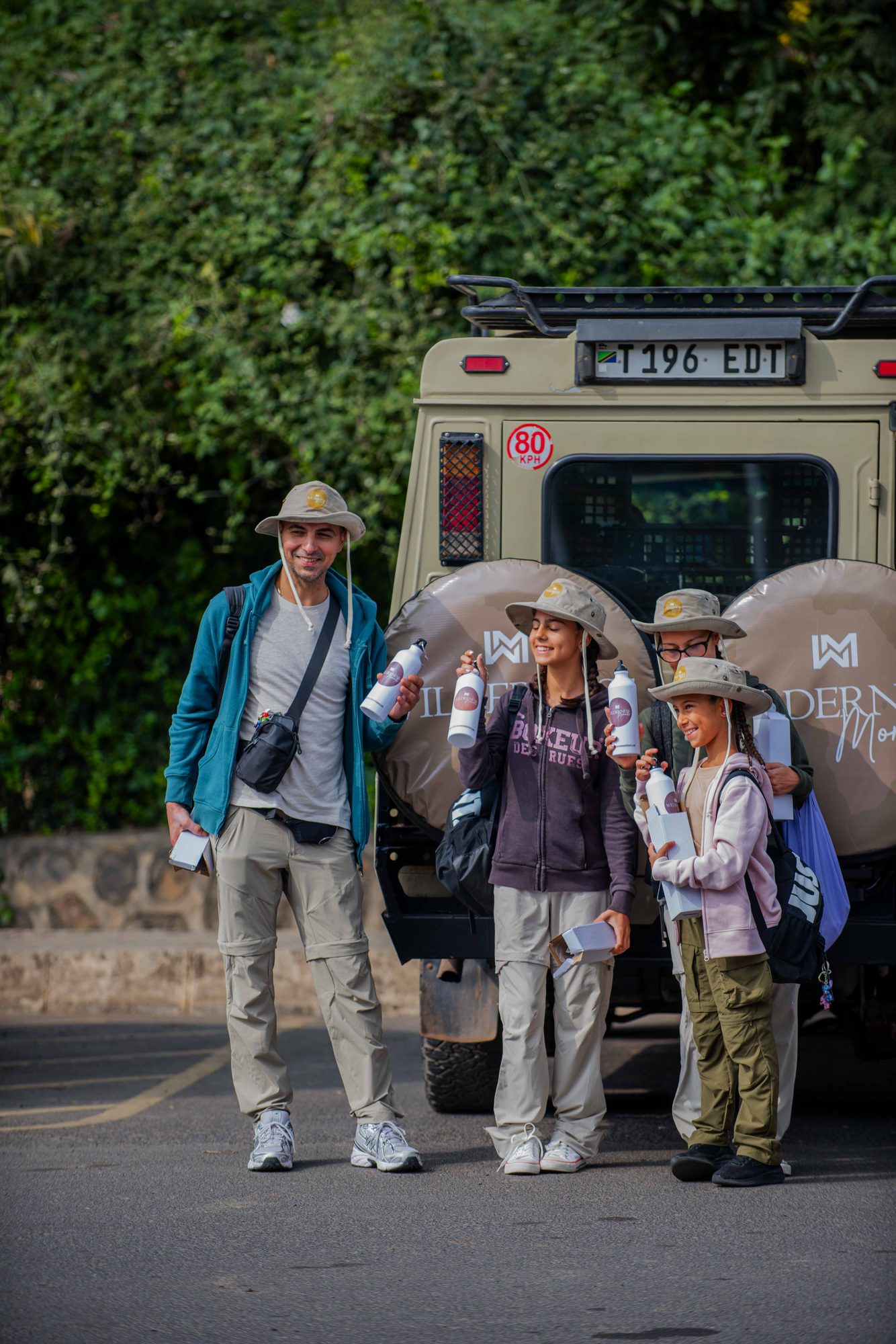 Guests gathering by the Land Cruiser before departure
