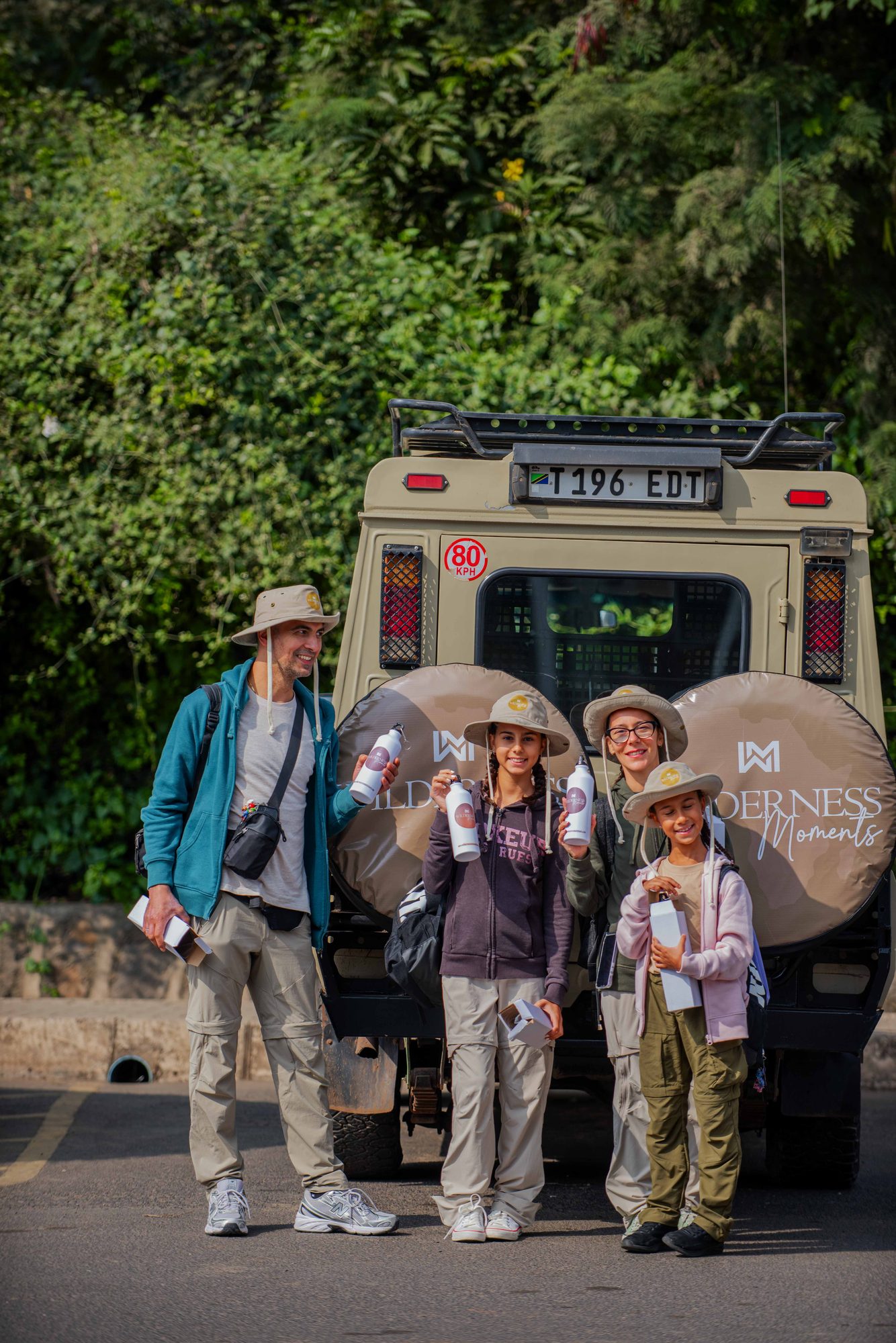 The whole group by our branded safari vehicle